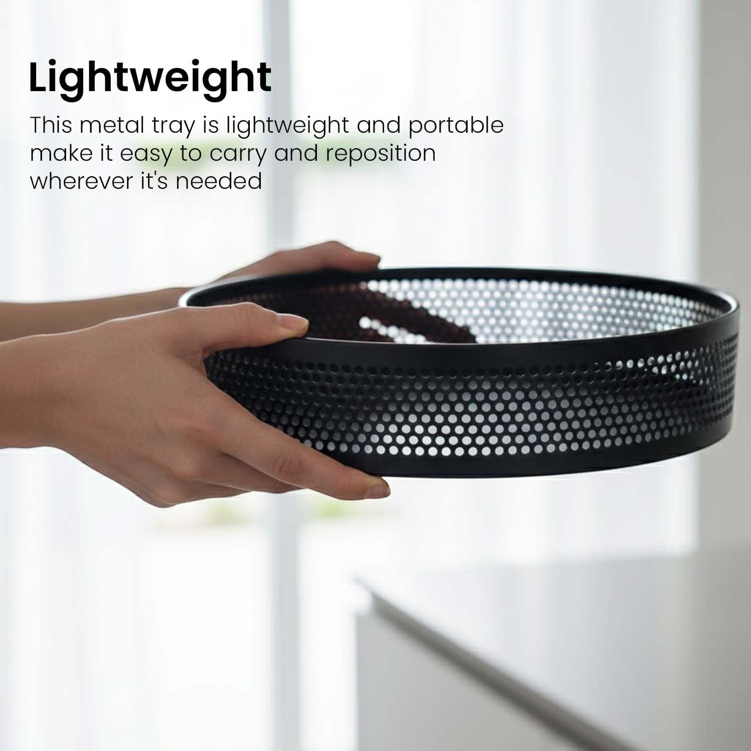 GoHooked black metal revolving fruit basket with a perforated design, perfect for countertop storage.