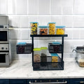 Go Hooked black metal 3-tier rotating storage rack with mesh baskets and clear containers filled with food items.