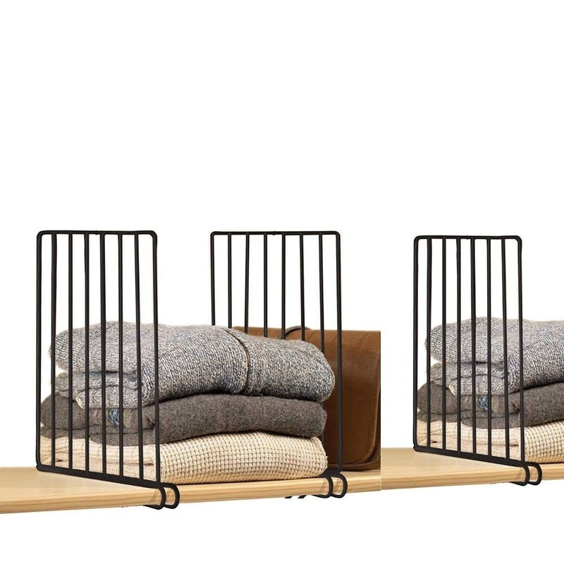 Go Hooked black metal shelf dividers organizing folded sweaters and a brown bag on a wooden shelf.