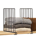GoHooked black metal shelf dividers organizing folded sweaters and a brown bag on a wooden shelf.