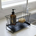 GoHooked black metal sink organizer with auto drain design, holding dish soap and sponge on a countertop.