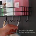 GoHooked black metal wall-mounted storage basket with 4 hooks, holding bottles and a loofah.