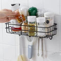 Go Hooked black metal wall mounted storage basket with hooks, holding spice jars and kitchen utensils.