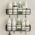GoHooked Set of 2 black metal wall mounted storage baskets with hooks, holding toiletries and bottles on a tiled wall.