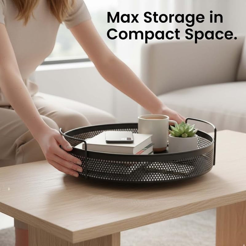 GoHooked round black metal storage tray with perforated sides and handles, holding books, a mug, and a plant.