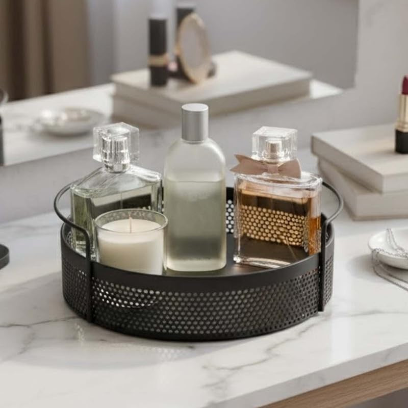 GoHooked black round metal storage tray with perforated sides and handles, holding perfume bottles and a candle.