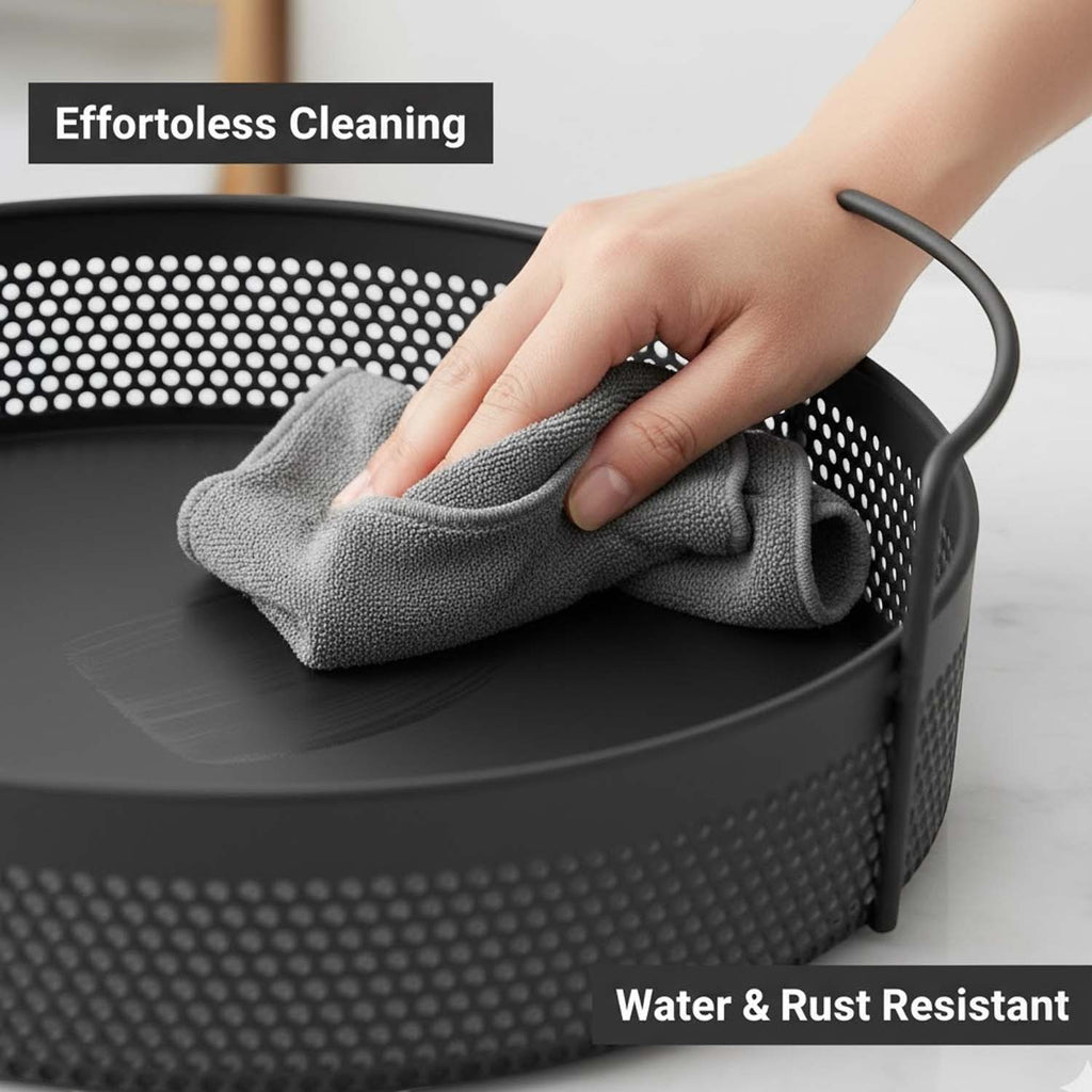GoHooked black round metal storage tray with perforated sides being wiped clean with a grey cloth