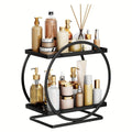 GoHooked black 2-tier metal vanity storage organizer with various toiletries and cosmetics. Features a circular frame and square shelves.
