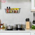 GoHooked black metal wall mount basket organizer holding spices and bottles in a kitchen.