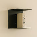 GoHooked black heavy duty iron wall mounted book shelf with a Vogue book.