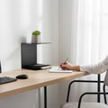 GoHooked black heavy duty iron wall mounted shelf with a plant and books. Ideal for study room.