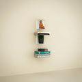 Go Hooked heavy duty black iron wall shelves displaying books, a plant, and a decorative statue.