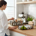 Go Hooked black metal wire grid kitchen organizer bins with handles, one holding spices and the other holding limes and rolled towels.