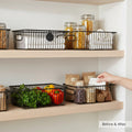 GoHooked black metal wire grid pantry organizer basket with handles, holding produce and dry goods.