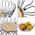 Go Hooked black metal wire fruit basket with a natural wood base, open design for airflow. Holds fruits.