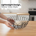 Go Hooked black metal wire fruit basket with a round wooden base, open design for airflow, 10-inch diameter.