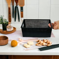 Go Hooked black plastic multipurpose storage basket with perforated sides and handles, ideal for kitchen or office.