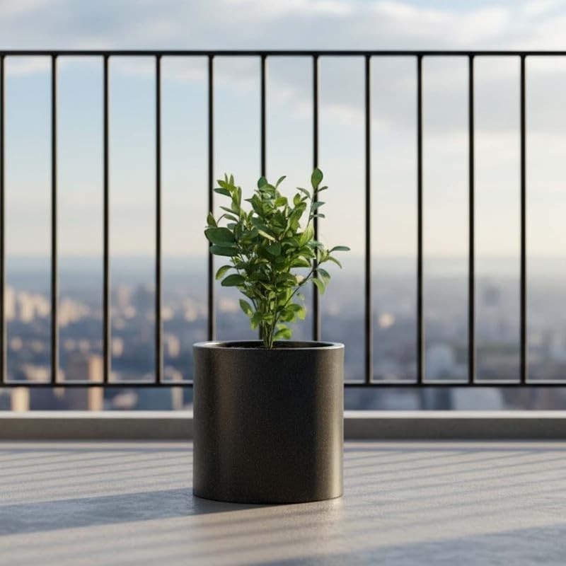 GoHooked 10 inch round black polymer planter with a small green plant on a balcony.