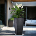 GoHooked 24-inch black geometric polymer planter with a peace lily plant.