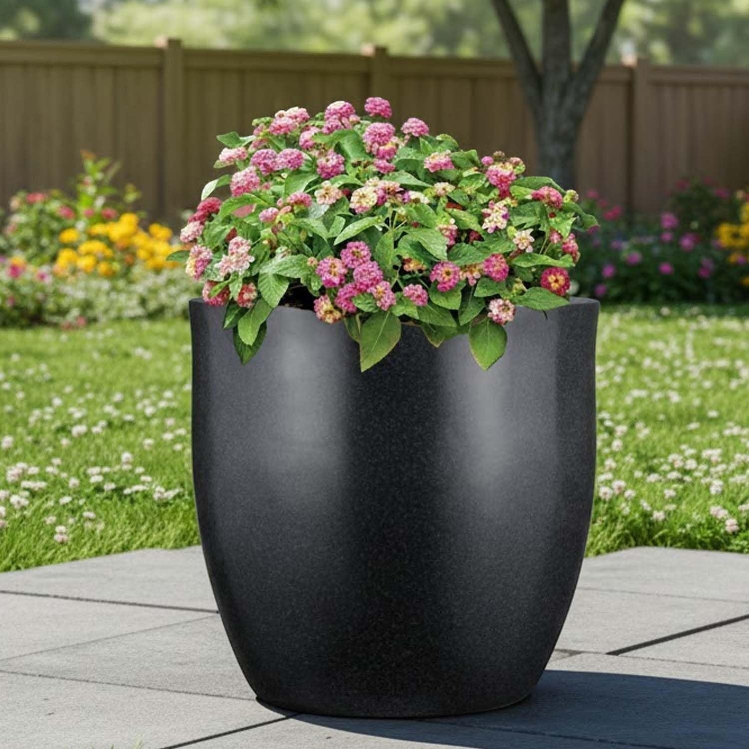 GoHooked 12-inch modern round black polymer planter with pink flowers, perfect for indoor or outdoor use.