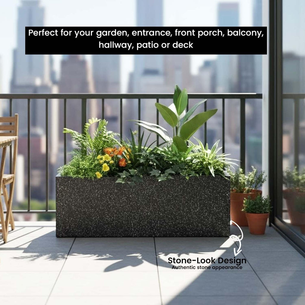 GoHooked black rectangular polymer planter with stone-look texture on a balcony, featuring lush green plants.