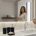 Go Hooked modern black ribbed plastic bathroom accessory set with soap dispenser, toothbrush holder, tumbler, and soap dish.