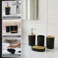 Go Hooked modern black ribbed plastic bathroom accessory set with soap dispenser, toothbrush holder, tumbler, and soap dish.