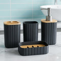 Go Hooked black ribbed plastic bathroom accessory set with bamboo lids and accents, includes soap dispenser, tumbler, toothbrush holder, and soap dish.