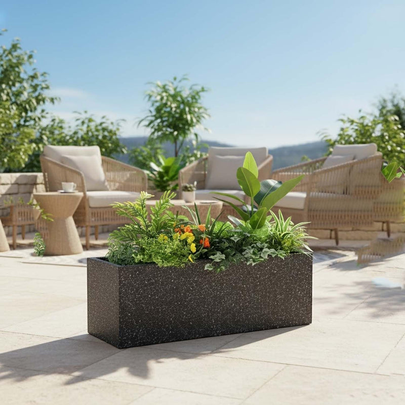 GoHooked black speckled rectangular polymer planter pot filled with lush green plants and small yellow flowers, perfect for balconies or gardens.