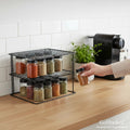 GoHooked black steel 2-tier corner shelf rack holding spice jars on a kitchen counter.