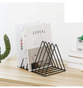 GoHooked black coated steel triangular magazine rack holding books and magazines on a wooden desk.