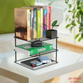Go Hooked black steel 3-tier shelf organizer holding books, a mouse, and power banks on a white table.