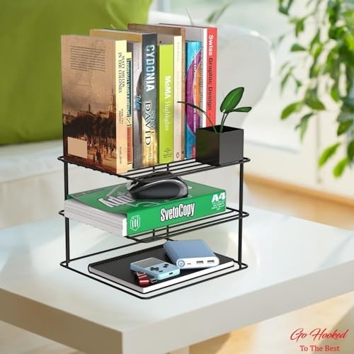 Go Hooked black steel 3-tier shelf organizer holding books, a mouse, and power banks on a white table.