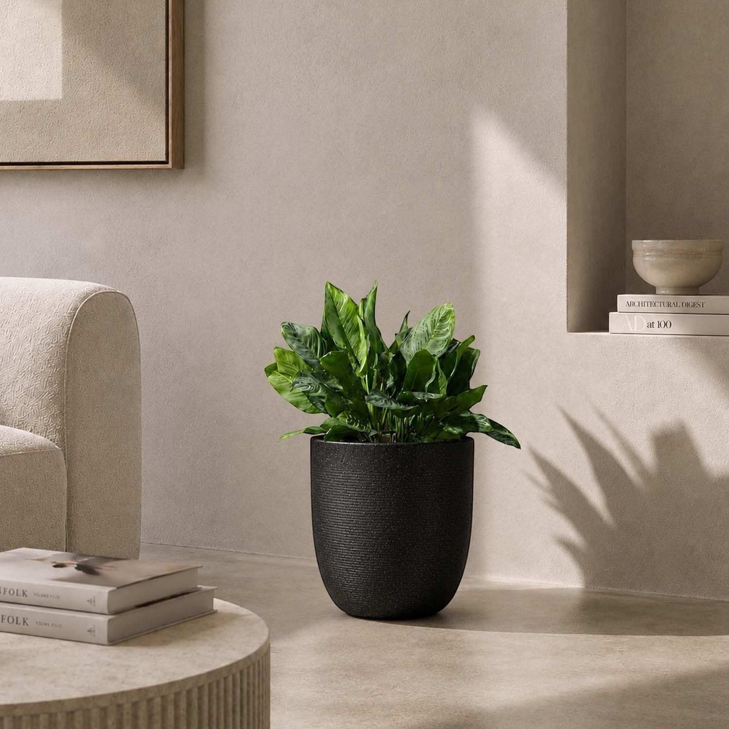 GoHooked 10-inch black textured polymer planter pot with a plant inside, perfect for indoor or outdoor use.