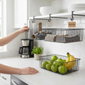 GoHooked black wire under shelf storage basket filled with kitchen items and another basket with apples and bananas.
