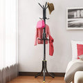 Go Hooked black wrought iron 3-tier coat rack with 12 hooks, holding a pink bag, pink sweater, red scarf, and a hat.