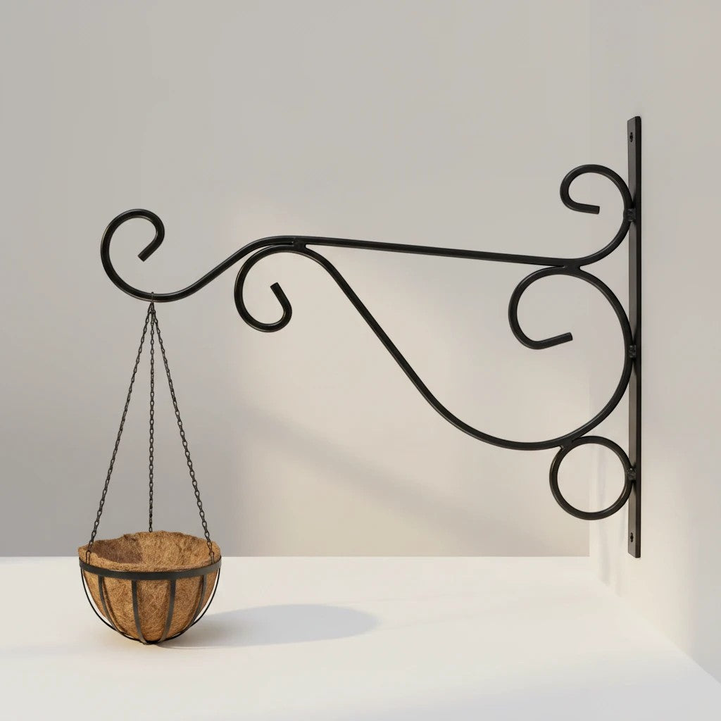 Go Hooked black wrought iron hanging planter bracket with decorative scrolls, holding a coconut coir basket.