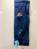 GoHooked blue 20-pocket over-the-door organizer made of non-woven fabric, with clear pockets for storage. Features a teddy bear, spray bottle, and cloth.
