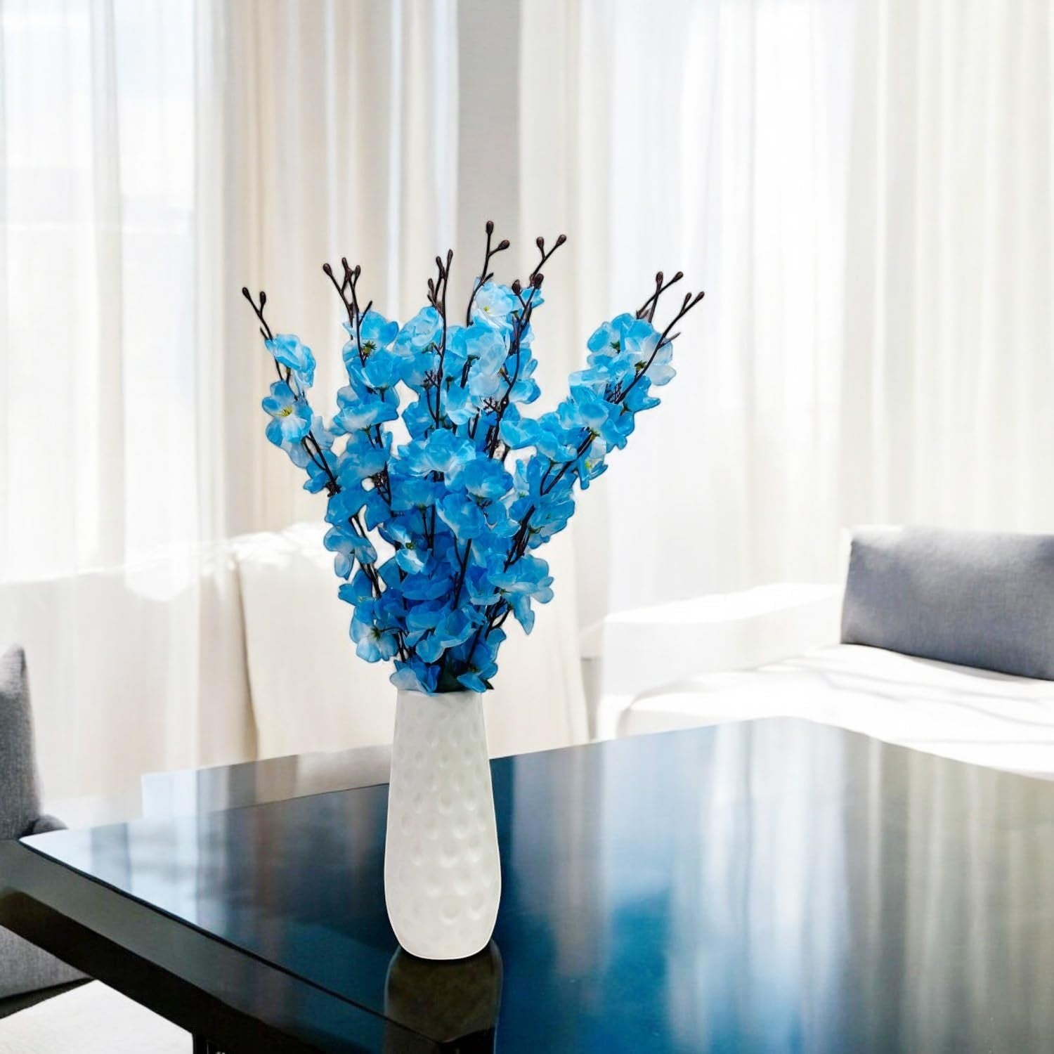 Go Hooked artificial blue blossoms in a white textured vase, a realistic and low-maintenance floral decor.