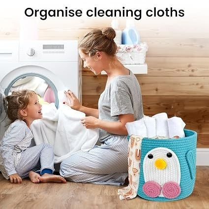 GoHooked blue cotton rope storage basket with a cute penguin design, used for organizing laundry in a home laundry room.