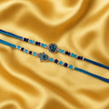 GoHooked blue and turquoise beaded rakhis with evil eye and hamsa charms on a gold satin background.