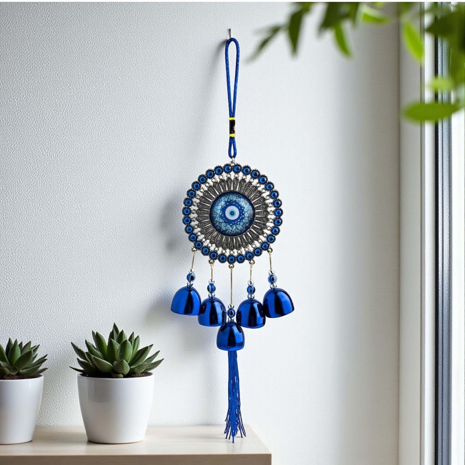 GoHooked blue evil eye metal wind chime with 5 brass bells and tassel, for positive energy and home decor.