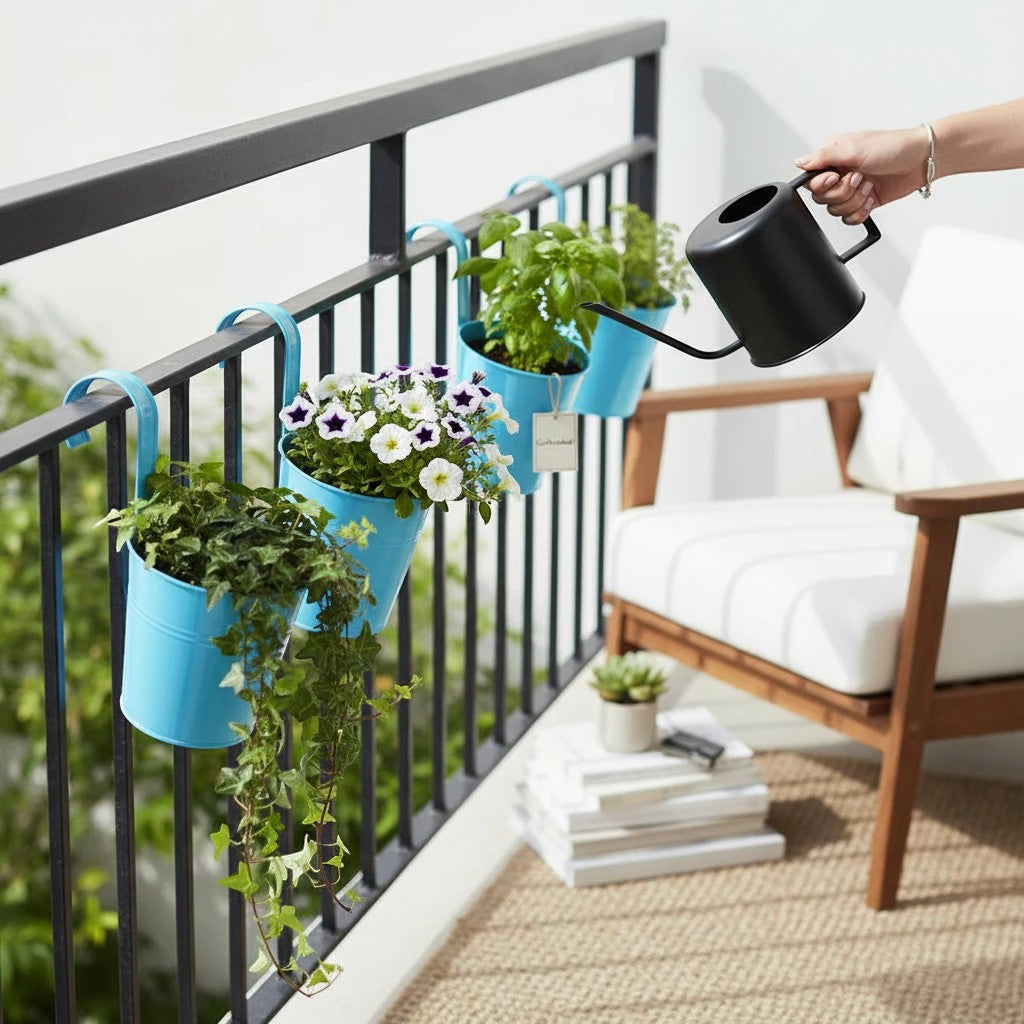 Go Hooked blue metal hanging planters with flowers and ivy on a balcony railing.