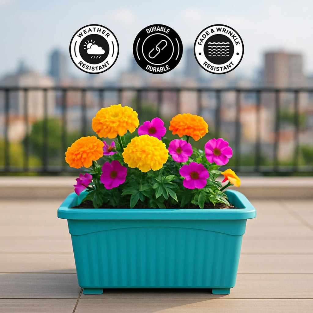 GoHooked blue rectangular plastic plant pot with fluted sides, holding marigolds and petunias on a balcony.