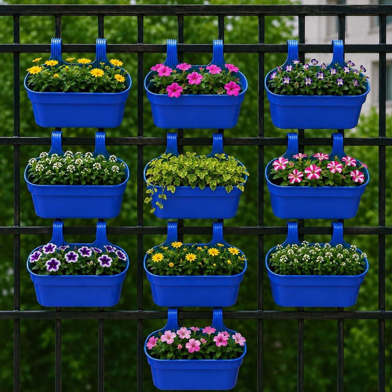 GoHooked blue plastic railing hanging planters filled with colorful flowers and greenery on a black fence.