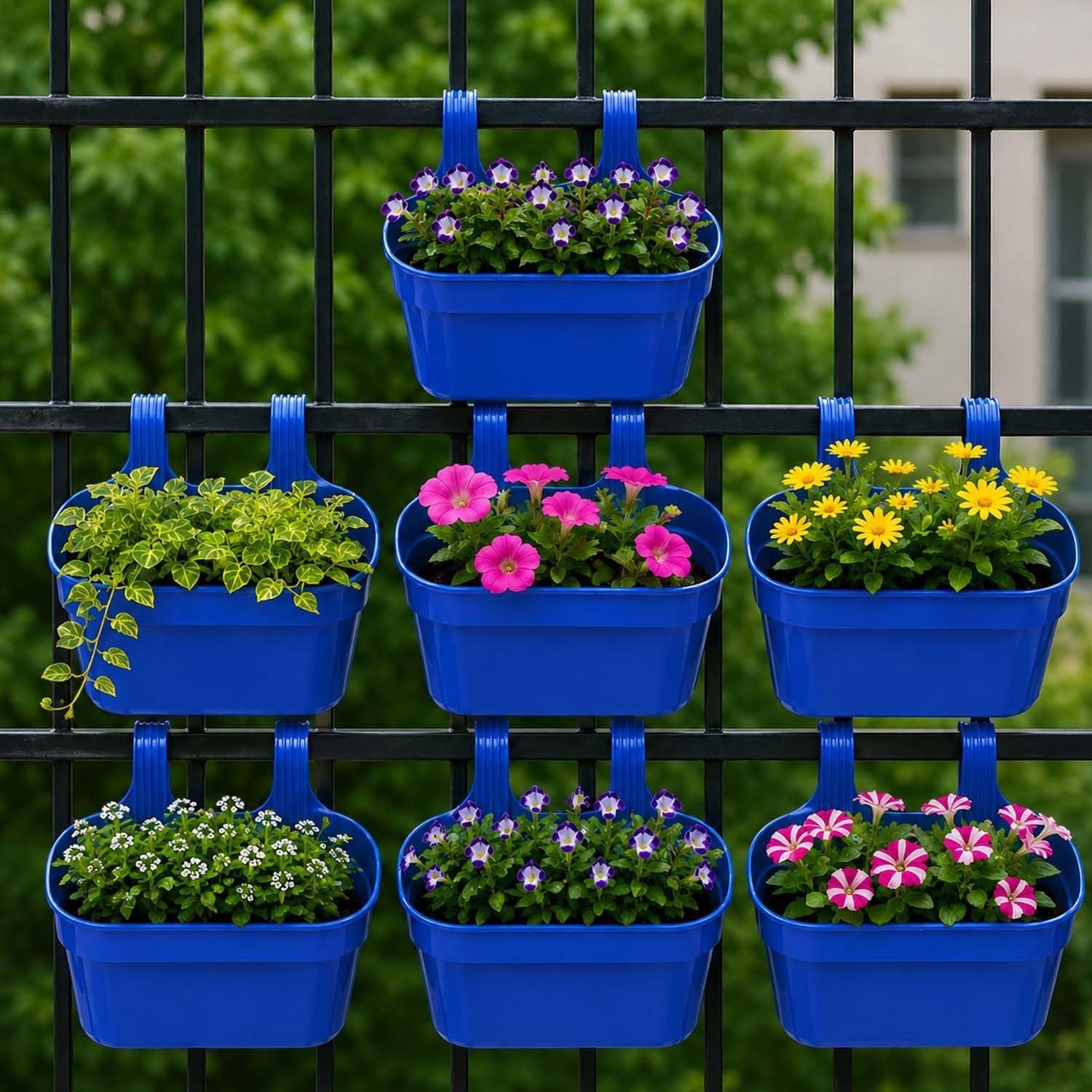 GoHooked set of 7 blue plastic railing planters with double hooks, holding various flowers like pink petunias and yellow daisies.