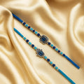 GoHooked blue designer Rakhis with evil eye and Hamsa hand charms, pearl beads, on satin.
