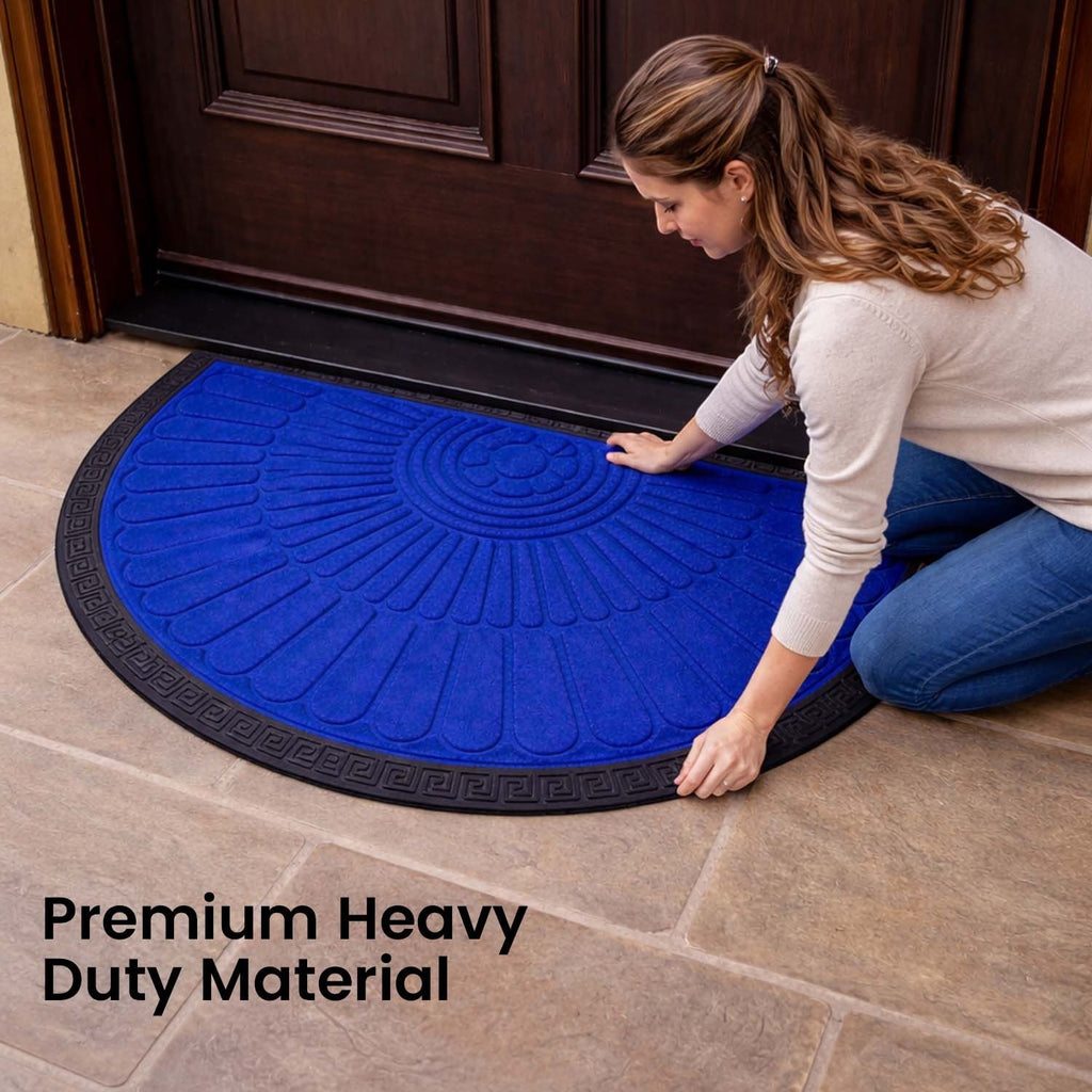 GoHooked royal blue semi-circle rubber door mat with black border, placed at a home entrance by a woman.