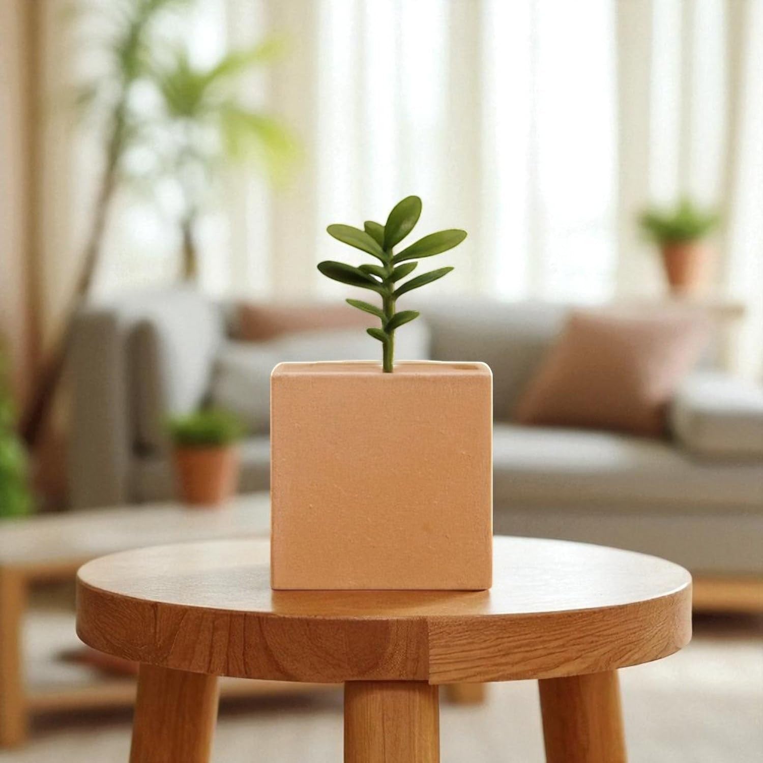 GoHooked brown polymer cube planter with a small green plant on a wooden table.