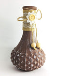 Go Hooked brown painted glass flower vase with textured base, burlap and lace trim, and button flower accent.
